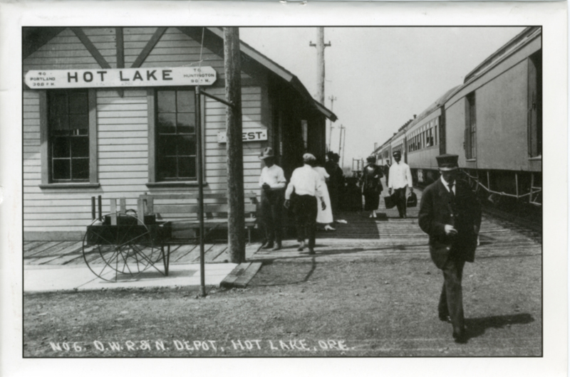 A postcard features an old photo of Hot Lake's train depot.