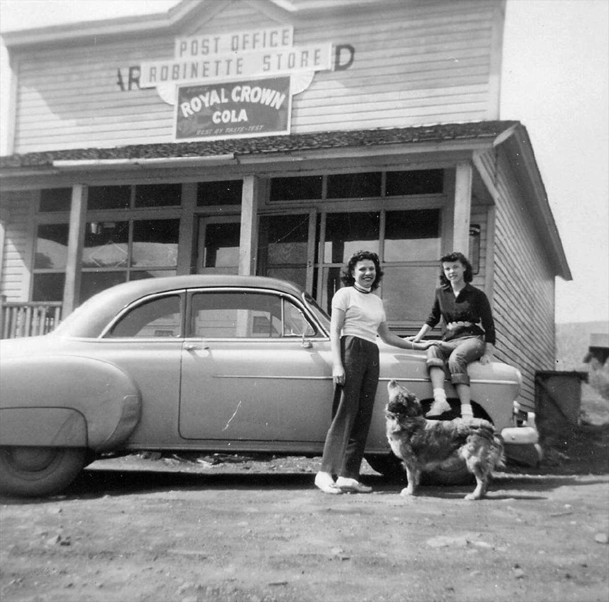 Robinette. Robinette Store and Post Office. Postmistress and store owner Francis "Frankie" Carrithers with daughter, Diane, and family dog Tojo. The store was located across the street from the depot. Before Robinette was inundated by waters from Brownlee Dam in 1958, the store was moved to Richland, where it stands today on Main St. Photo courtesy Baker County Public Library