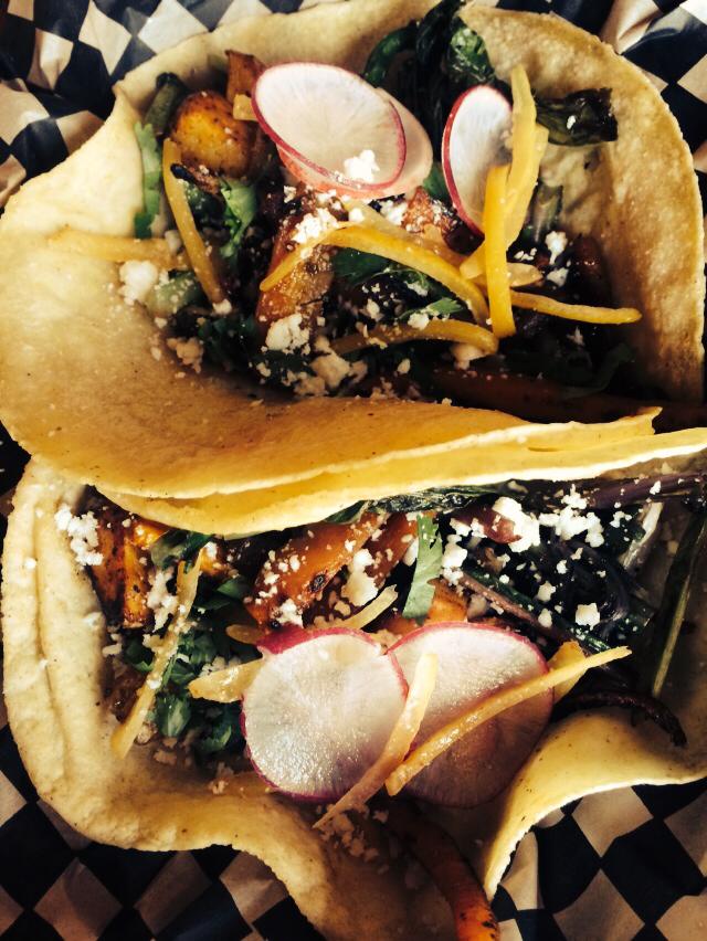 Seasonal veg taco with heirloom carrots, mustard greens, preserved lemons, spiced potatoes, radish, and cotija cheese.