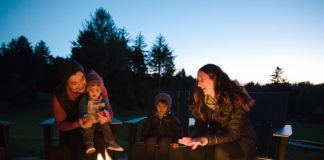 A family enjoying a fire in the fire pit at Salishan Lodge