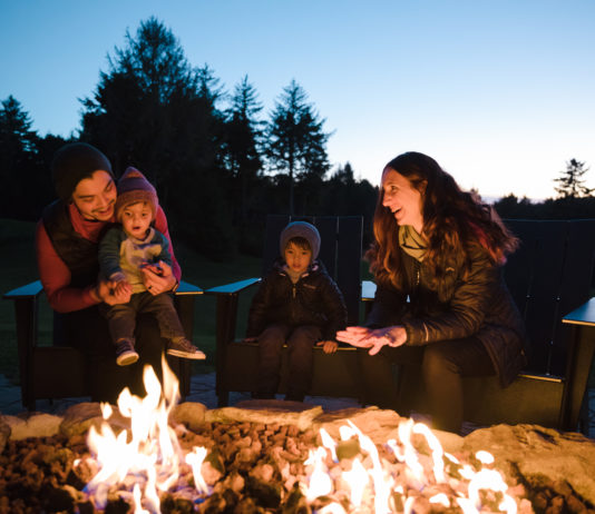 A family enjoying a fire in the fire pit at Salishan Lodge