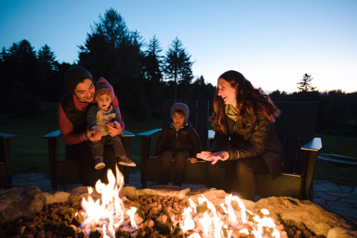 A family enjoying a fire in the fire pit at Salishan Lodge