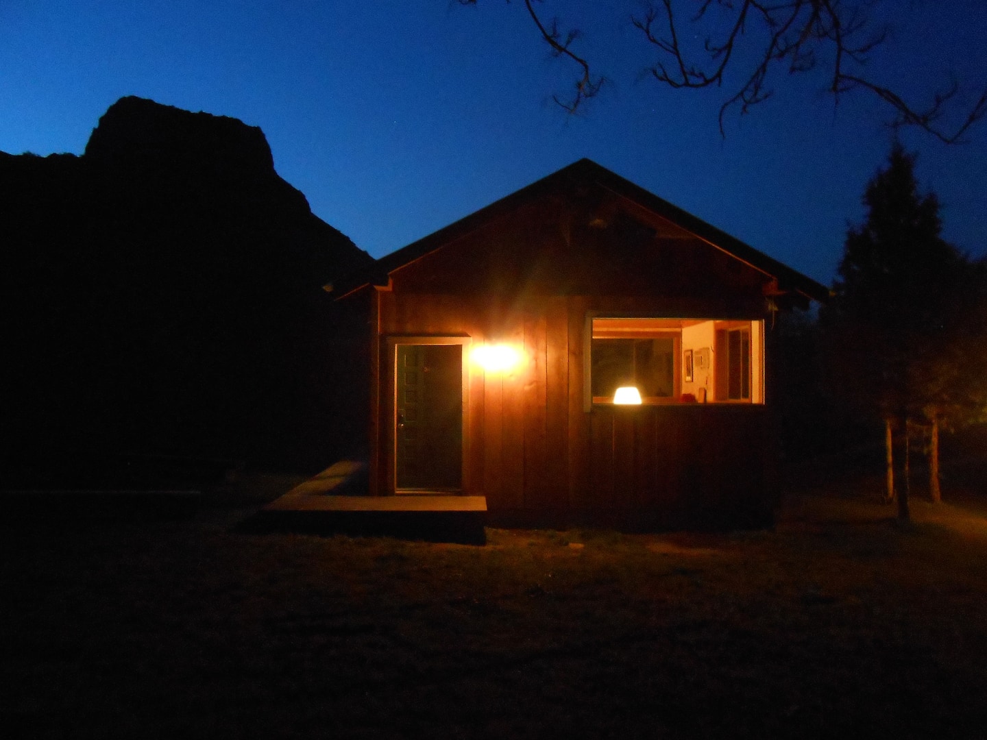 Cabin at dusk with Wedding Cake Mountain silhouetted in the background