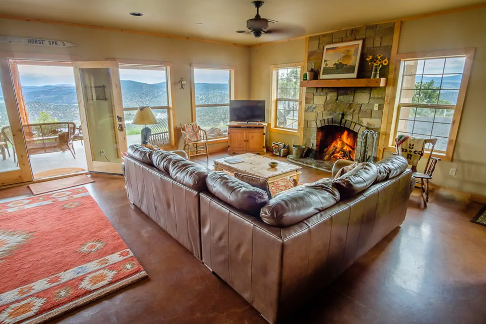 The living room with a couch and fireplace