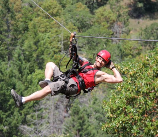 A person on a zipline at Rogue Valley Zipline Tour