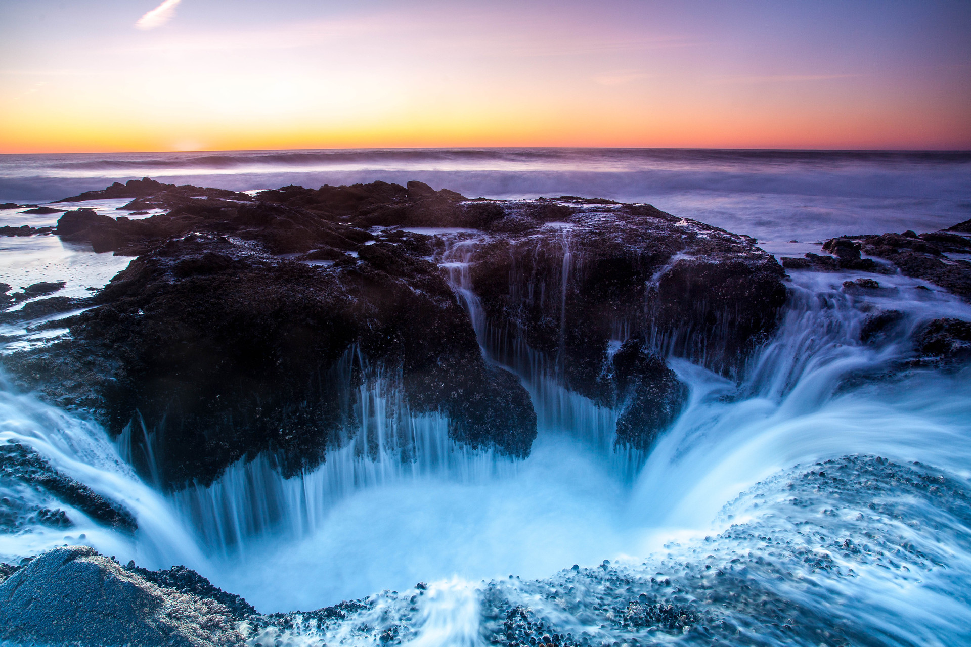 Thor's Well at sunset near Yachats Oregon.