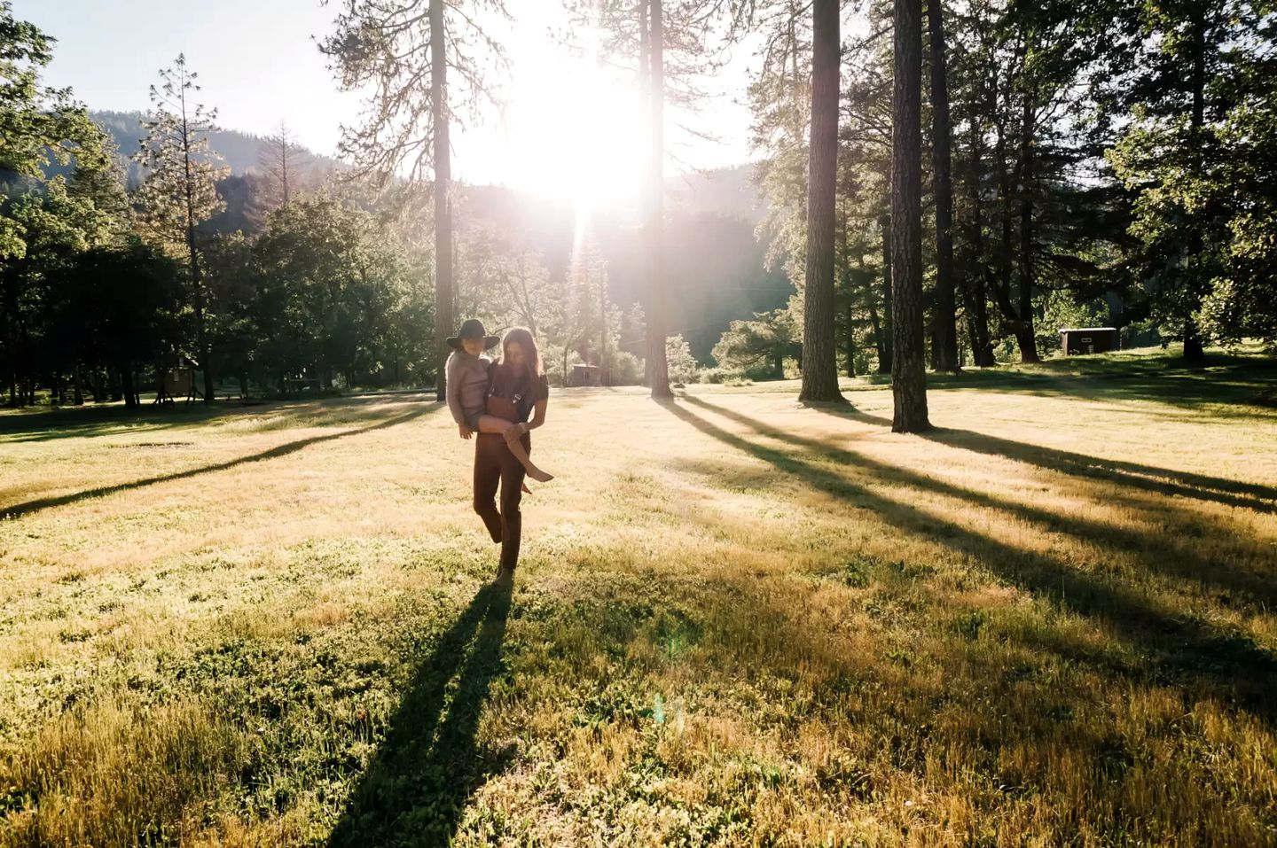 A woman and child walking in the woods