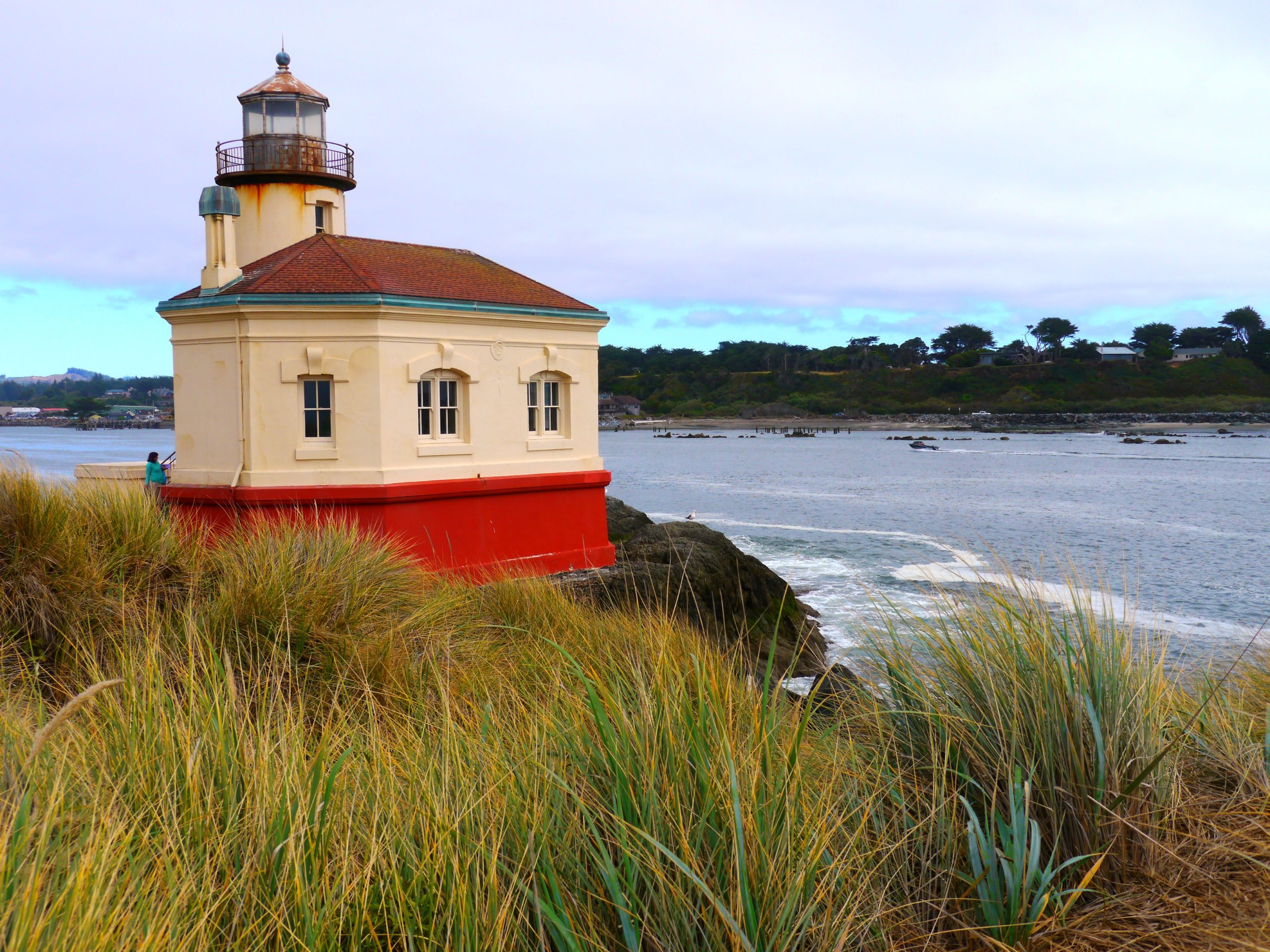 A tan and orange lighthouse on the Coquille River in Oregon.