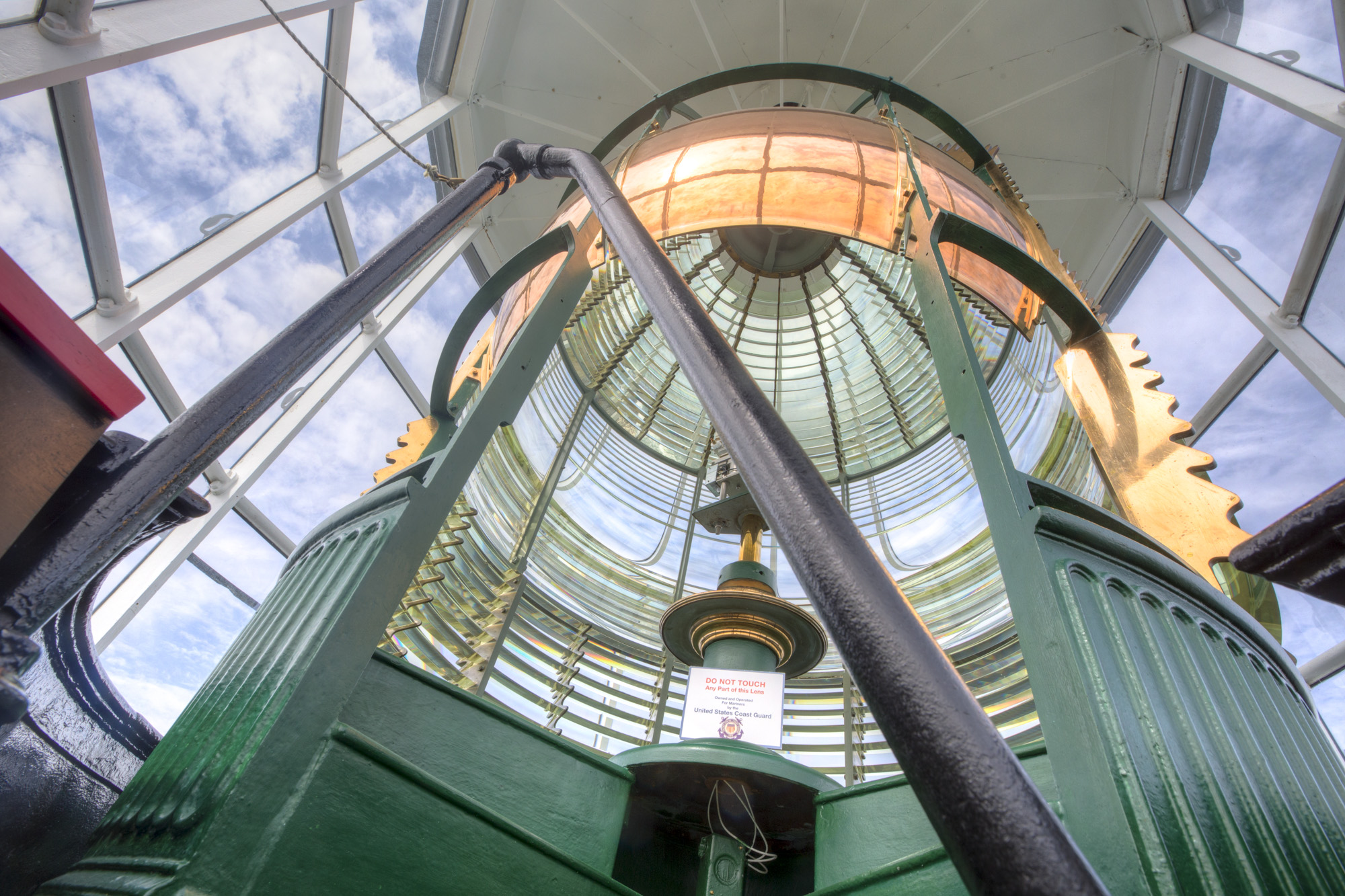 A massive lighthouse lens and light at Yaquina Head Lighthouse in Oregon.