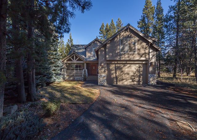 A gorgeous cabin in Sunriver Oregon surrounded by trees.