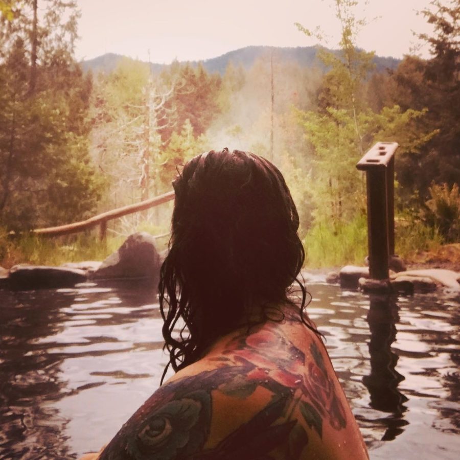 a tatooed person soaks at breitenbush hot springs oregon
