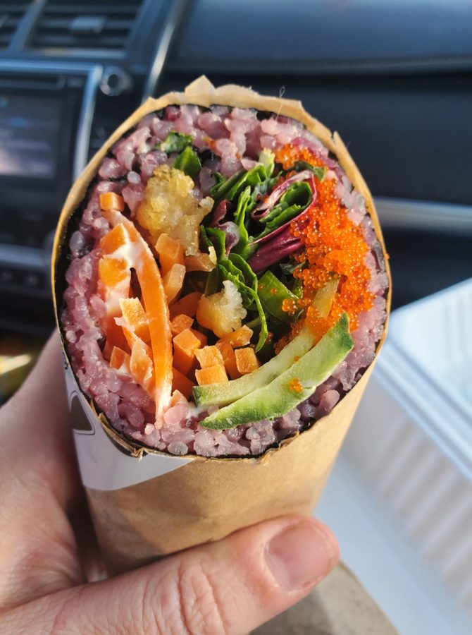 a sushi burrito eaten in the car