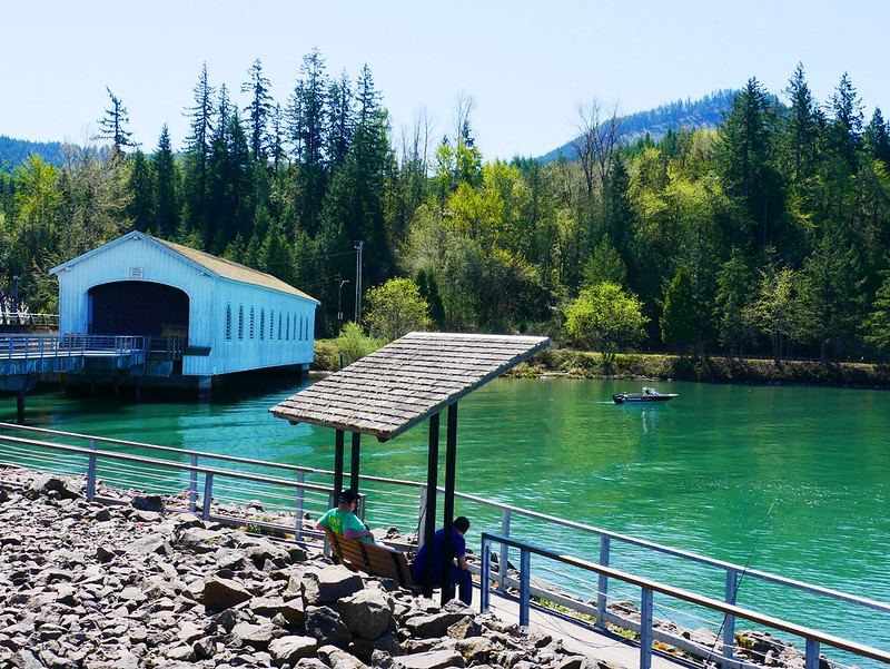 Lowell Covered Bridge Interpretive Center overlooking blue green waters of the Dexter Reservoir.