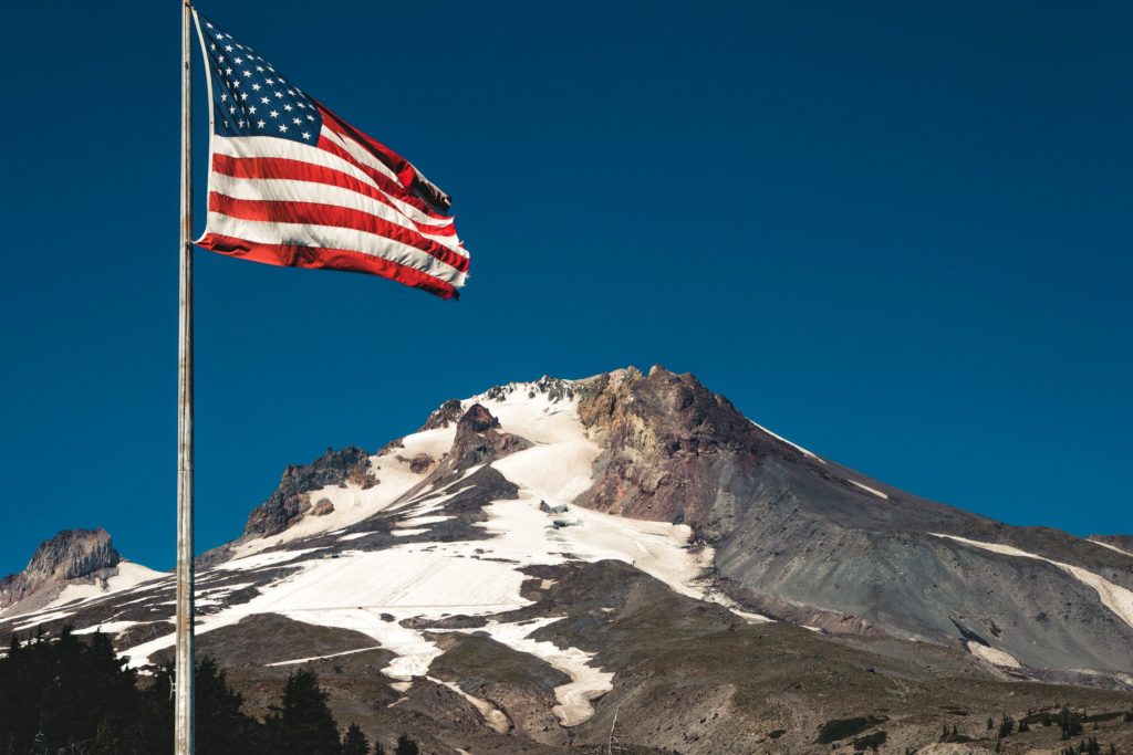 An American flag in the breeze in front of Mount Hood Oregon