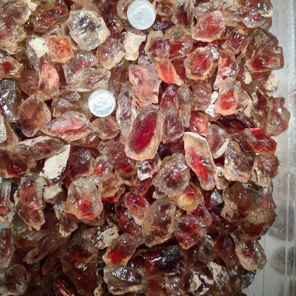 A box of red sunstones that are the size of a dime or larger.  They're very pretty.