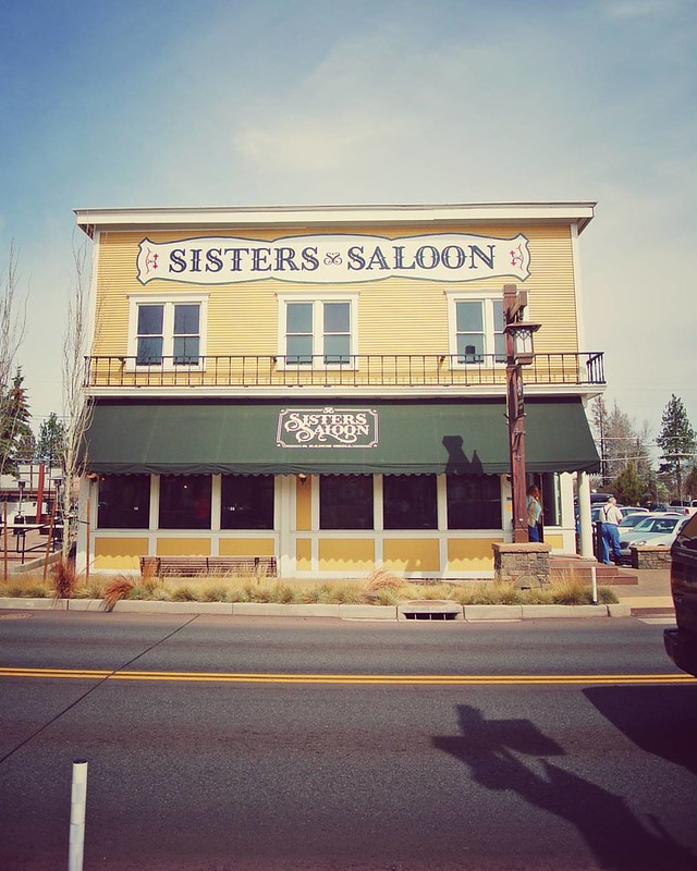 Sister's Saloon.  It's a yellow building with green accents., best oregon towns, spring road trip, best towns to visit, 2024