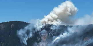 Fire raging on forested mountaintops near Cedar Creek