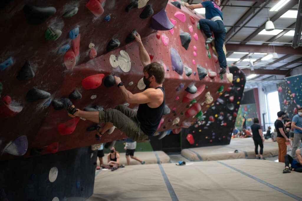 A person climbing the rock wall at Circuit Bouldering Gym In Oregon