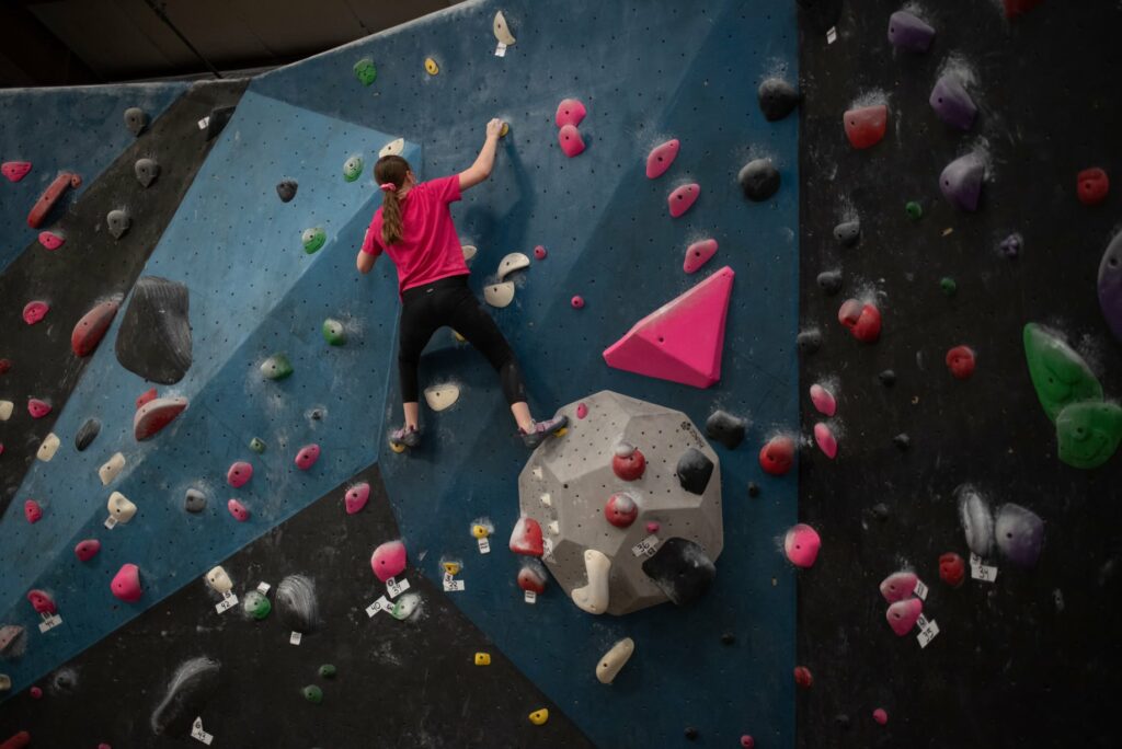 A person climbing the rock wall at Circuit Bouldering Gym In Oregon