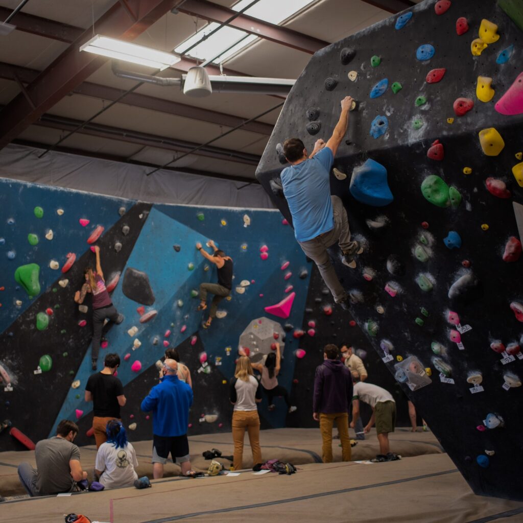 A person climbing the rock wall at Circuit Bouldering Gym In Oregon