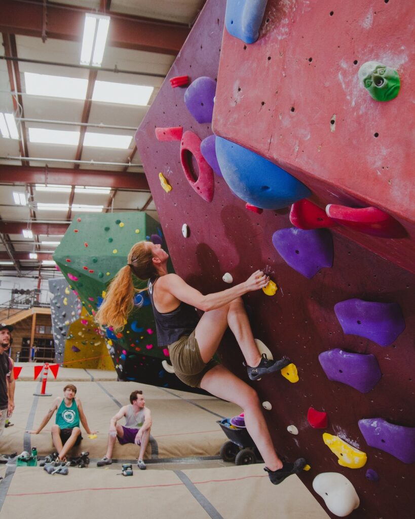 A person climbing the rock wall at Circuit Bouldering Gym In Oregon