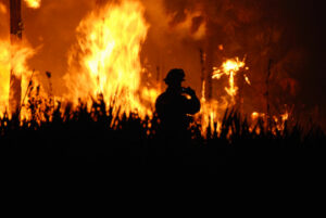 Fireman in front of wildfire