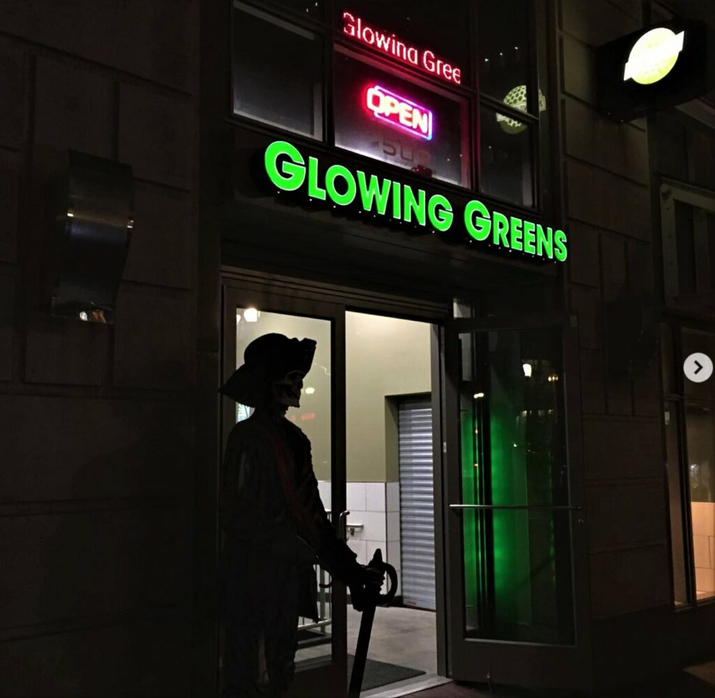 Glowing Greens building exterior at night