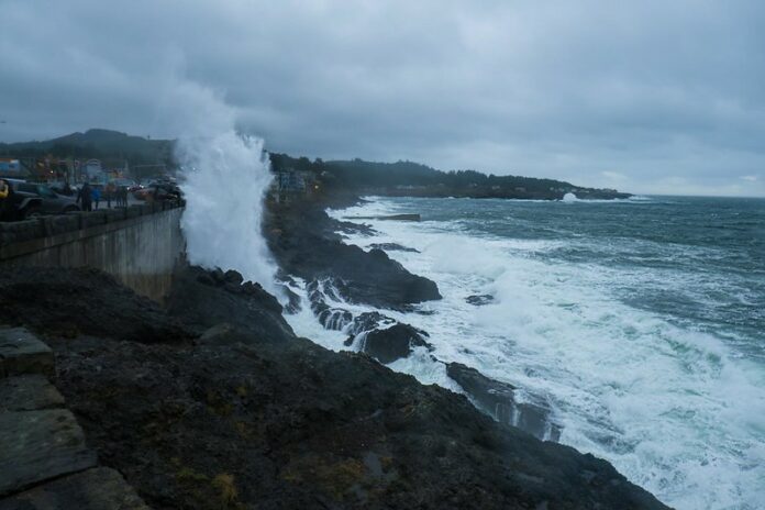 Massive King Tide Wave hitting a rock on the Oregon coast on a stormy day