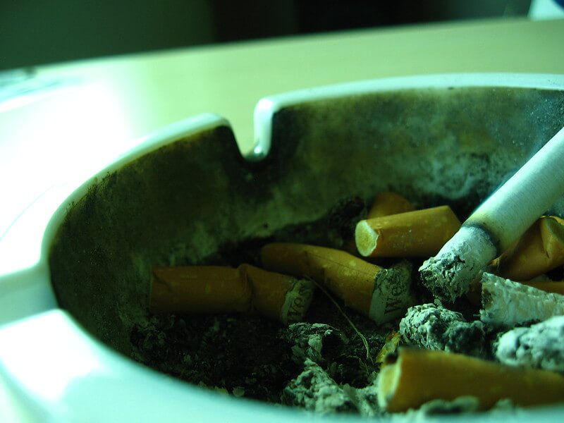 Cigarette burning in ashtray