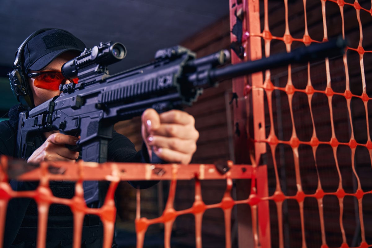 Shooter wearing eye and hearing protection while practicing at a supervised range