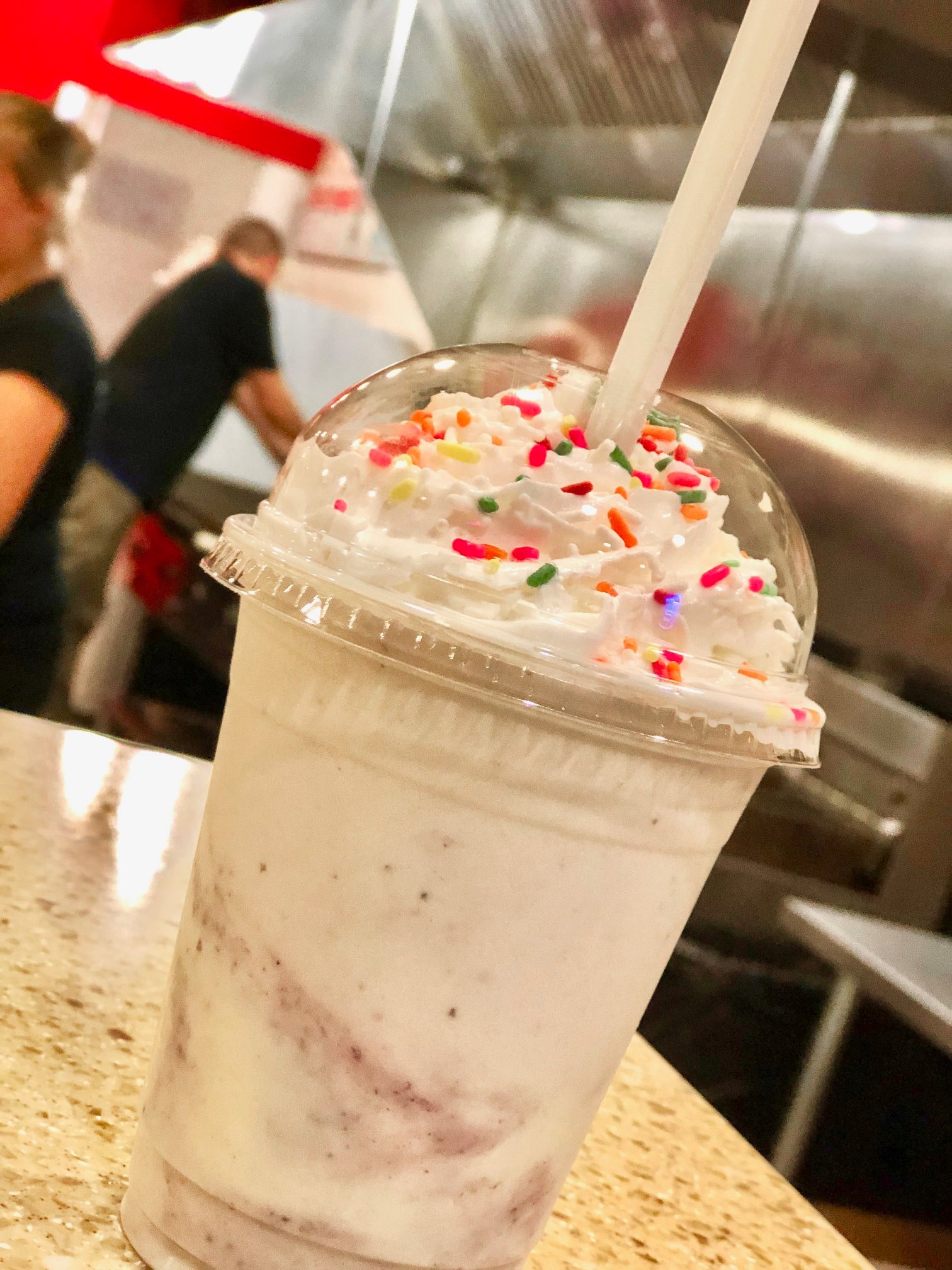 A milkshake with whip cream and rainbow sprinkles on top from Bogey's Burgers in Redmond, Oregon.