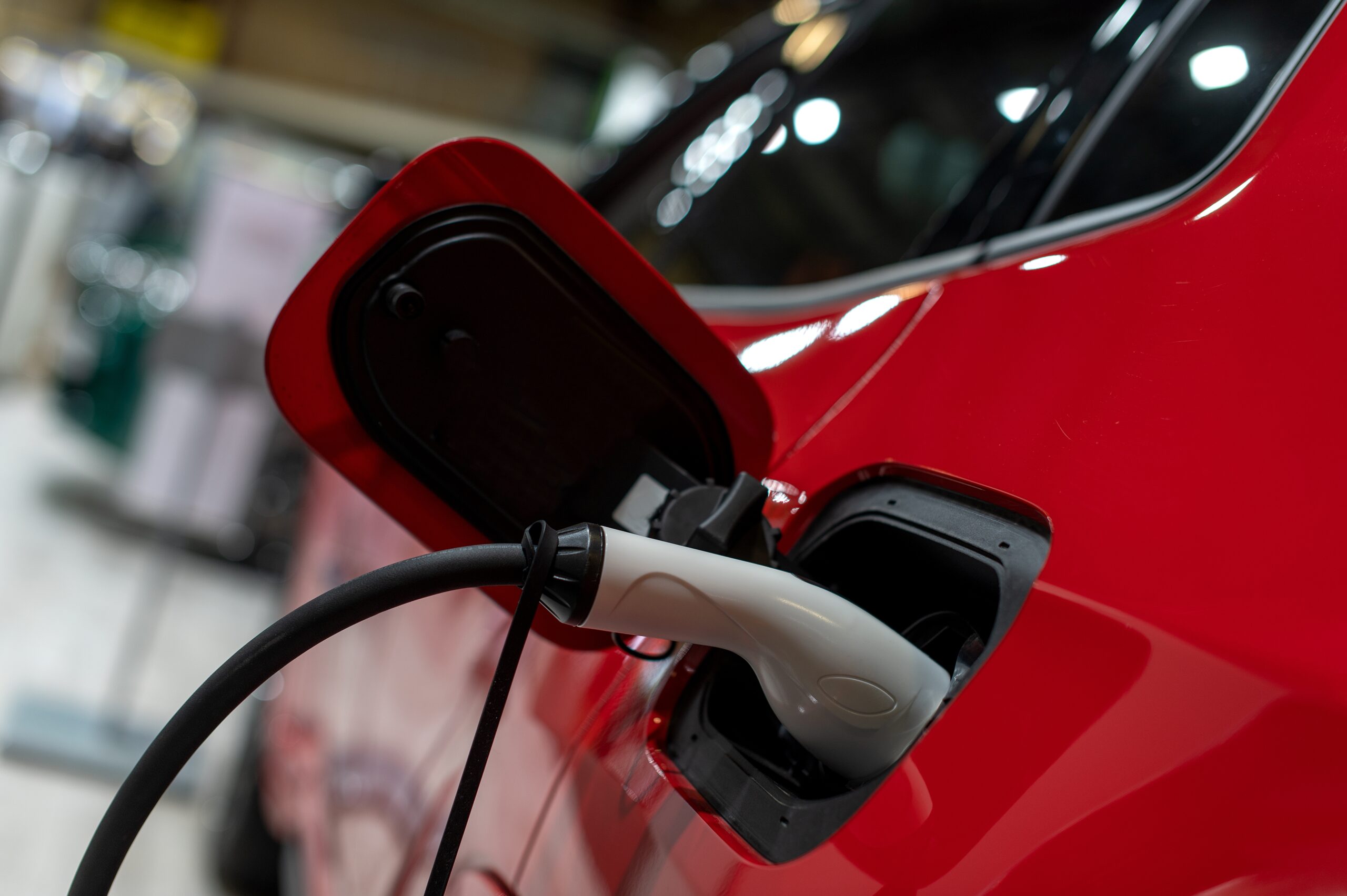 A red EV electric car charging.