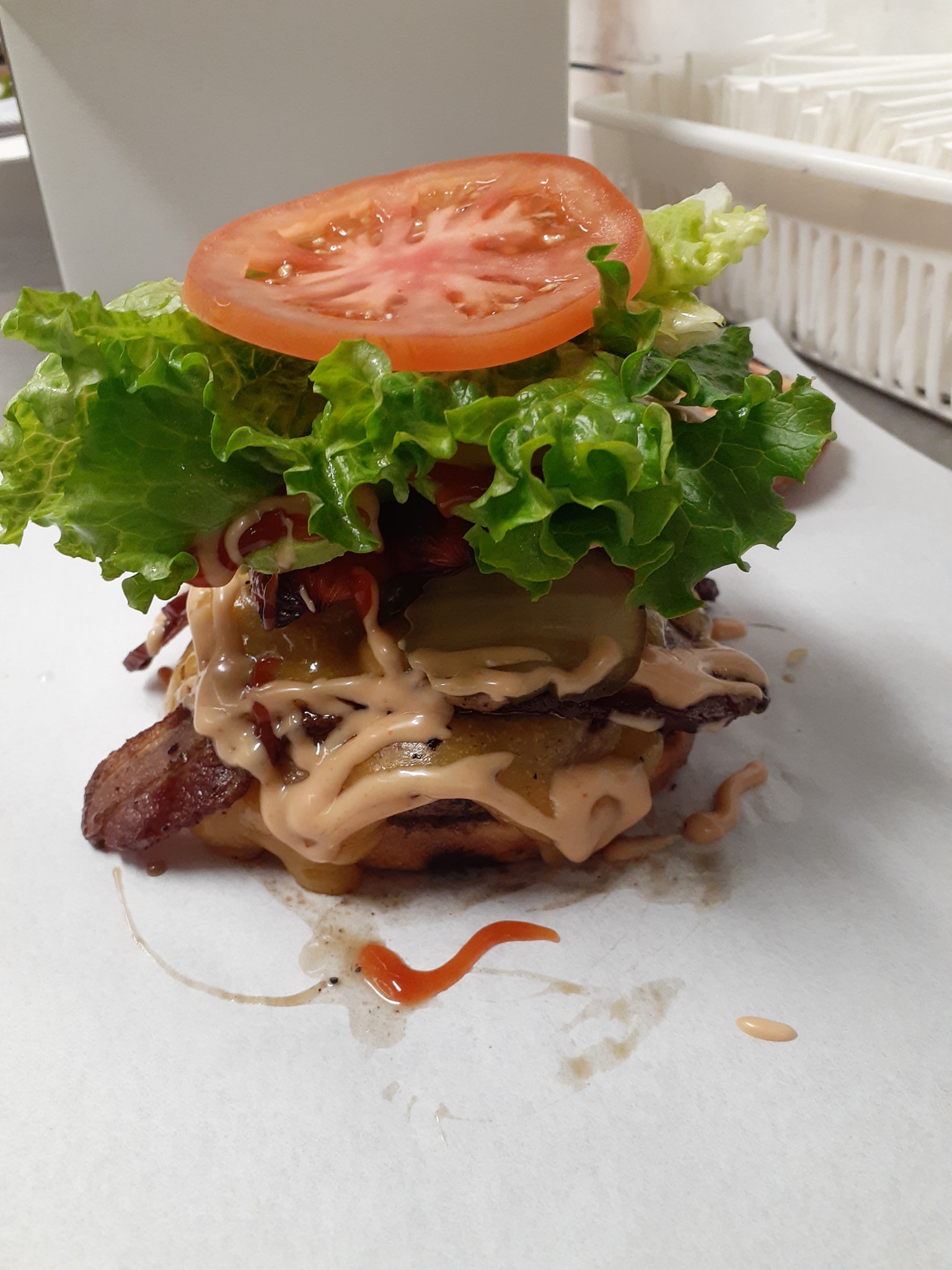 A burger piled high with toppings from Five Stars Family Burger in Cornelius Oregon