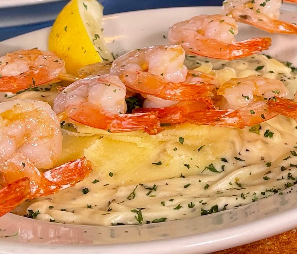 A plate of food with lemon and shrimp from Mo's in Newport, Oregon