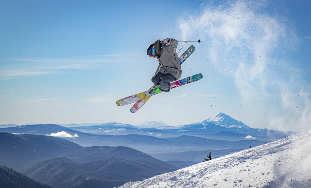 Someone jumping high in the air with ski's and doing a trick at Cooper Spur on Mount Hood