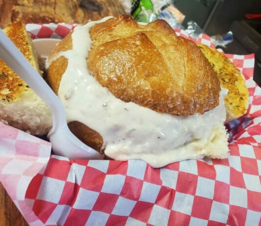 A bread bowl full of thick clam chowder at The Hungry Clam.