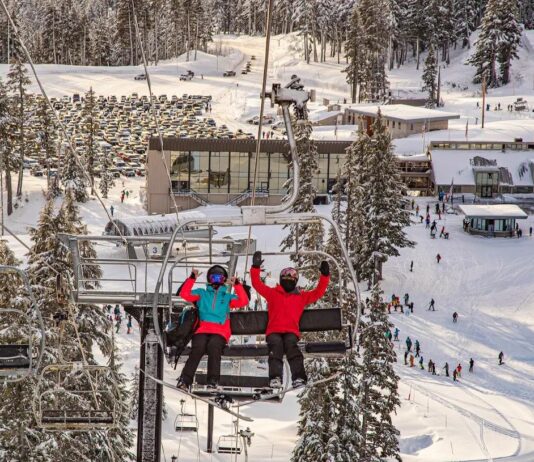 Two people sitting on a chairlift at Cooper Spur Mountain Resort at Mt. Hood