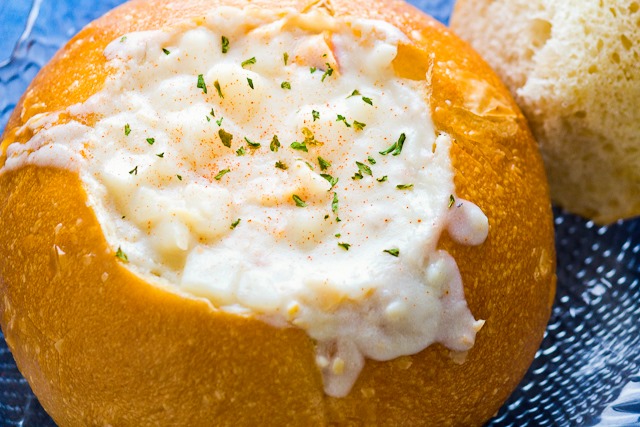 Clam chowder spilling out of a fresh bread bowl at Mo's