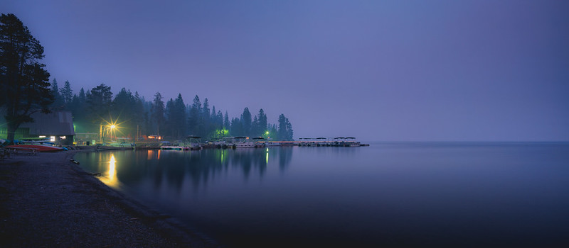 Diamond Lake at night in the fog with boats along the shore.