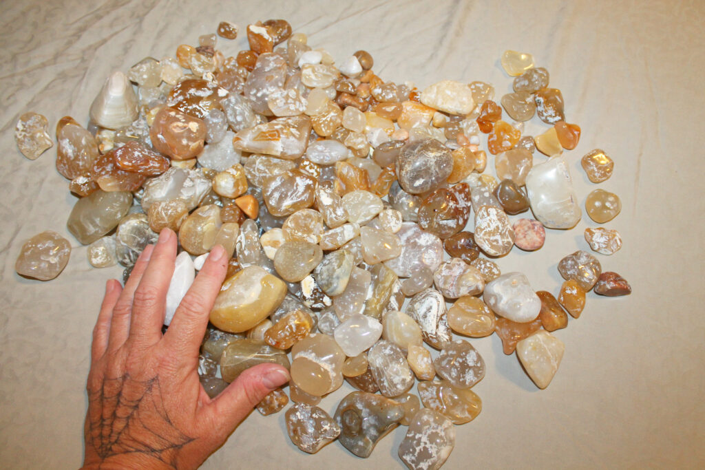 a hand with colorful oregon beach agates