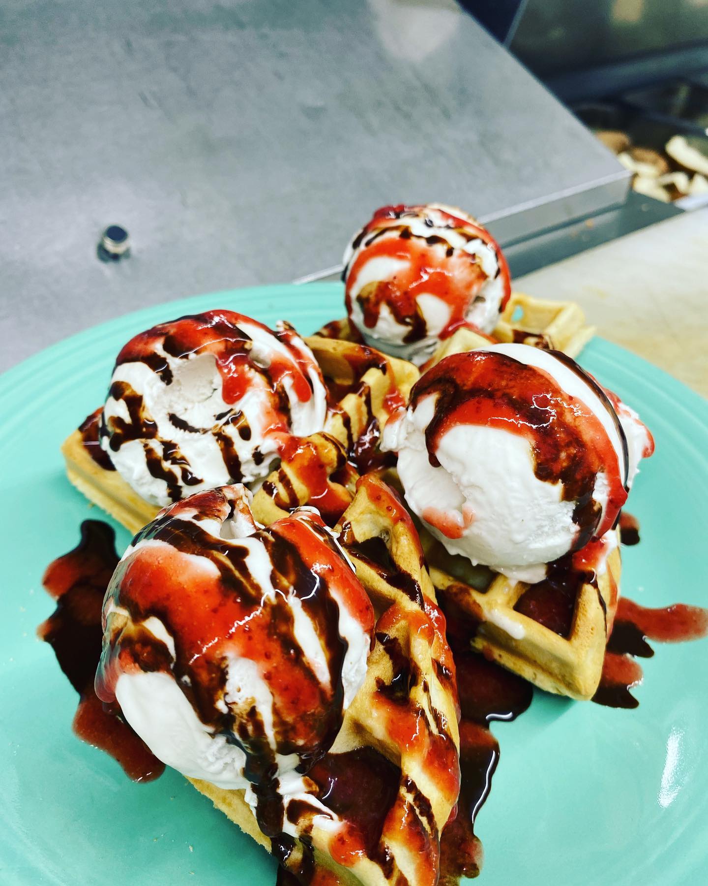 Delicious looking gelato on a waffle and drizzled in red sauce and chocolate sauce at the Cornbread Cafe.