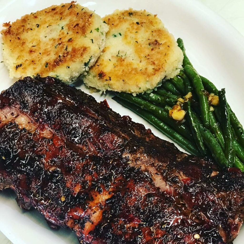 Jerked baby back ribs with bacon and cheddar potato cakes.