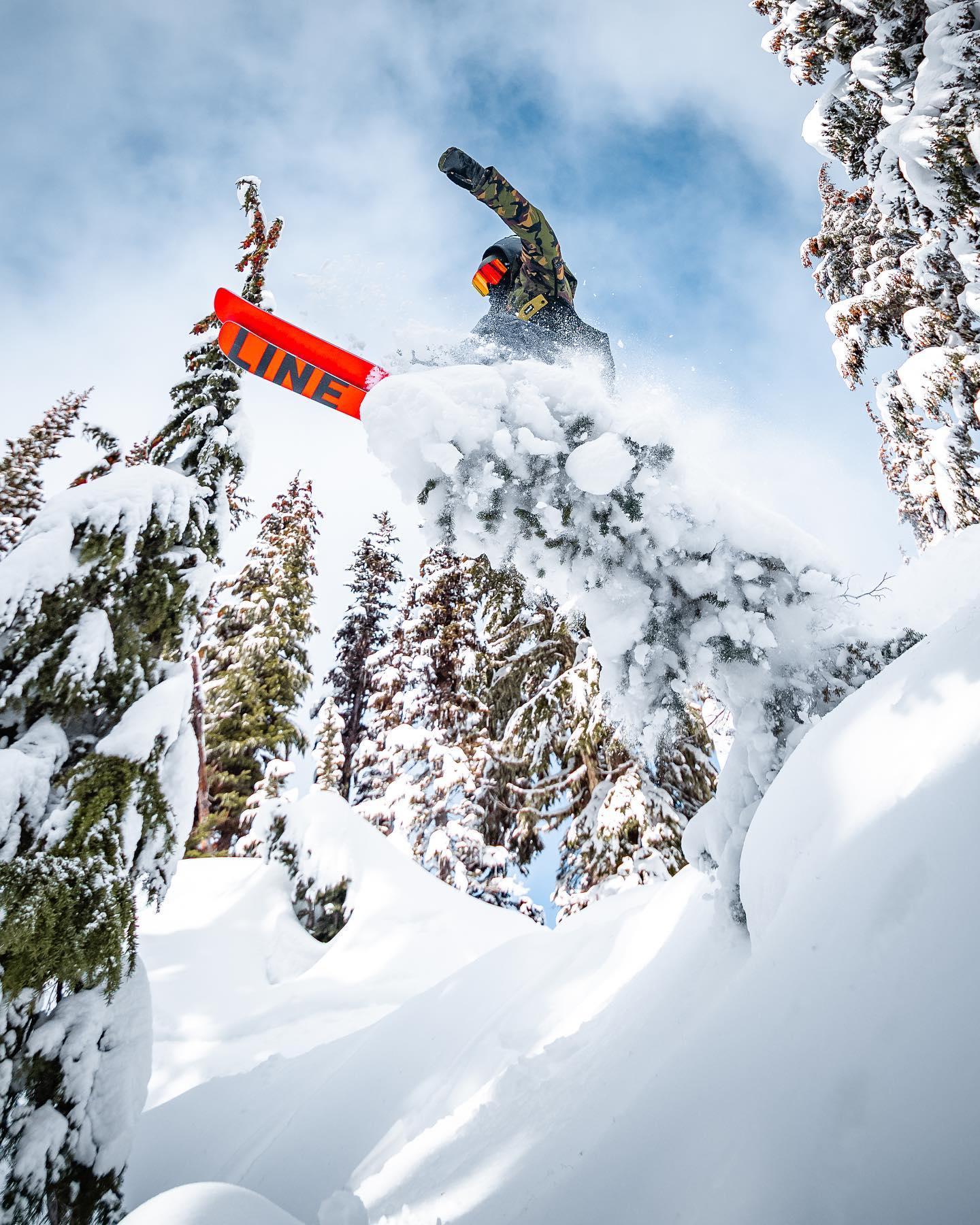 Someone jumping their red snowboard in deep powder at Timberline Lodge Ski Area.