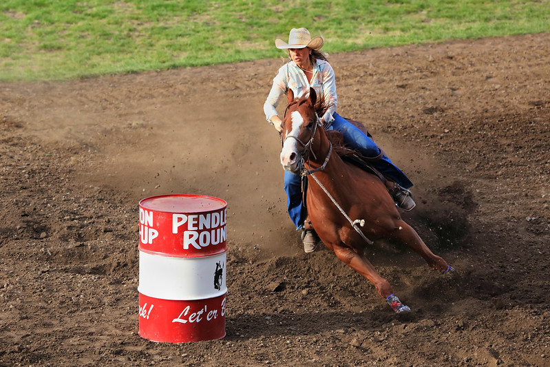 Round-Up, Pendleton, woman barrel racing on horse