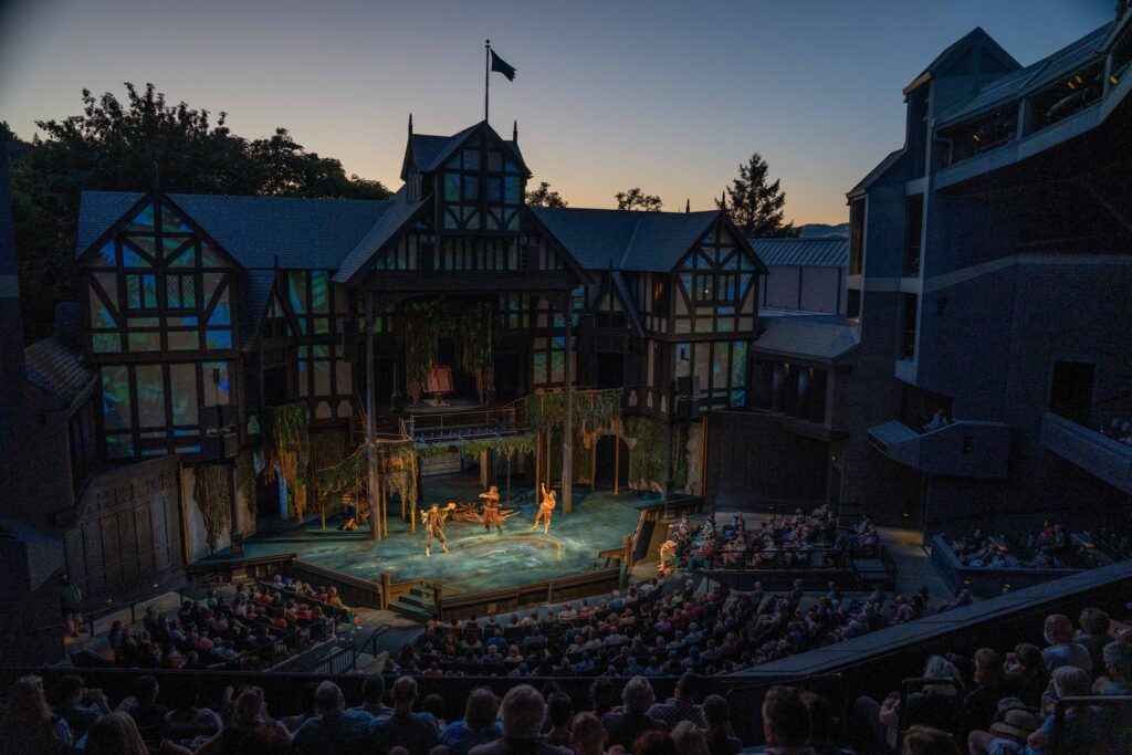 A play being put on at the Shakespeare Festival in Ashland Oregon at twilight.