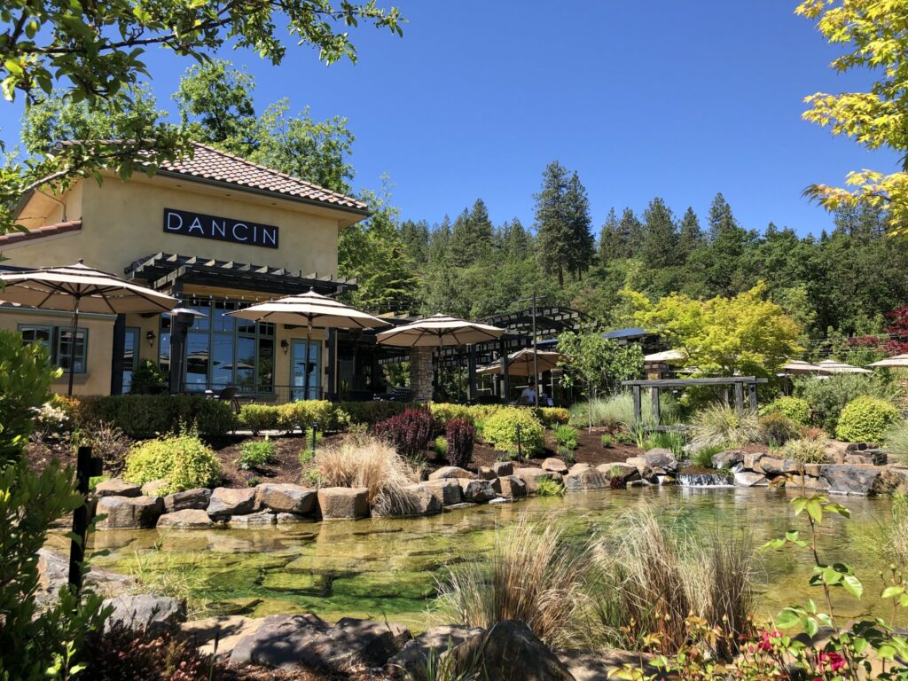 The pond at Dancin Vineyards with the patio and building behind it. It's a pretty space.