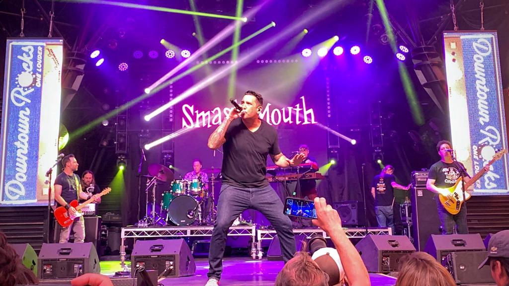 The singer on stage with lights behind him.