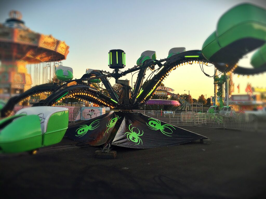 A black and green octopus type carnival ride.