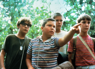 A photo of the four childhood actors in the movie Stand By Me. One is pointing at something.