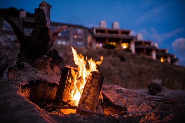 A bonfire on the beach in the evening in front of the Headlands Lodge.
